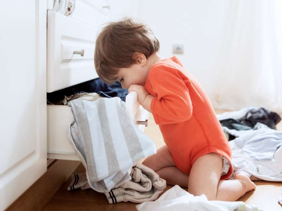 child looking into drawer