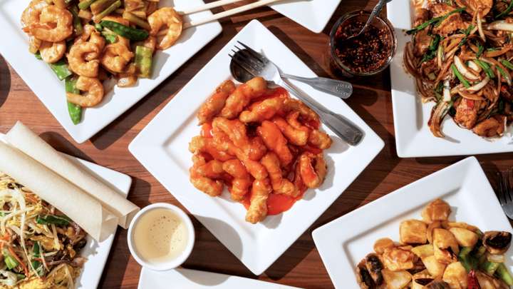 Different types of Chinese food on plates.