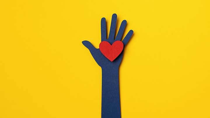 illustrated hand reaching up holding a heart