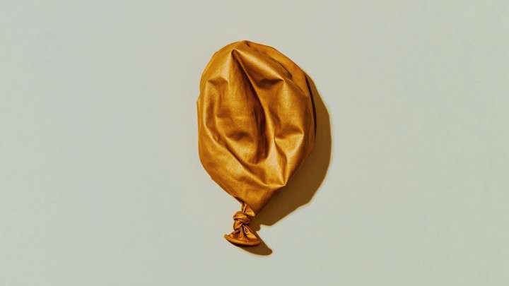 A deflated gold balloon