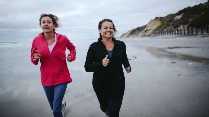 Two women jogging on the beach