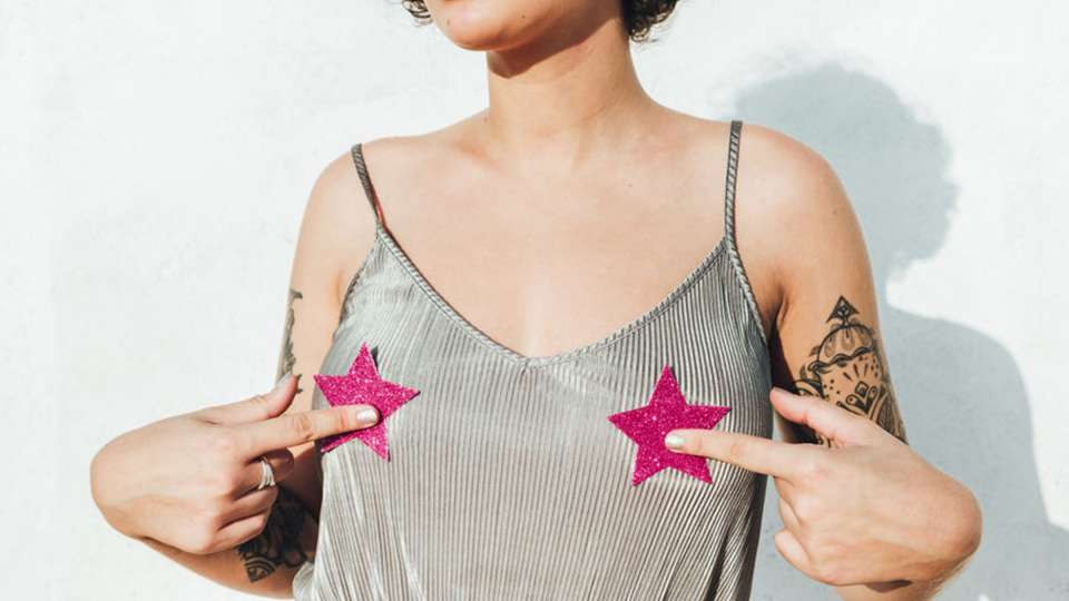 Woman wearing tank top with stars on nipples