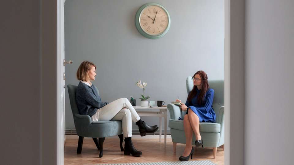A therapist speaks with a client.