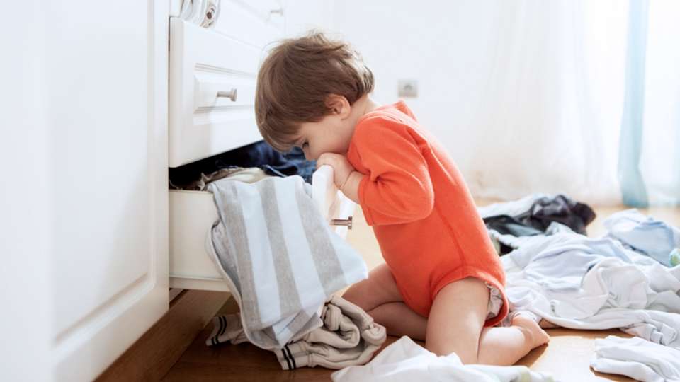 child looking into drawer