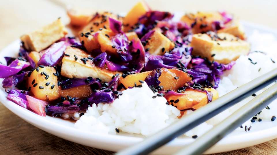 A meal of rice, purple cabbage, sweet potatoes and tofu.