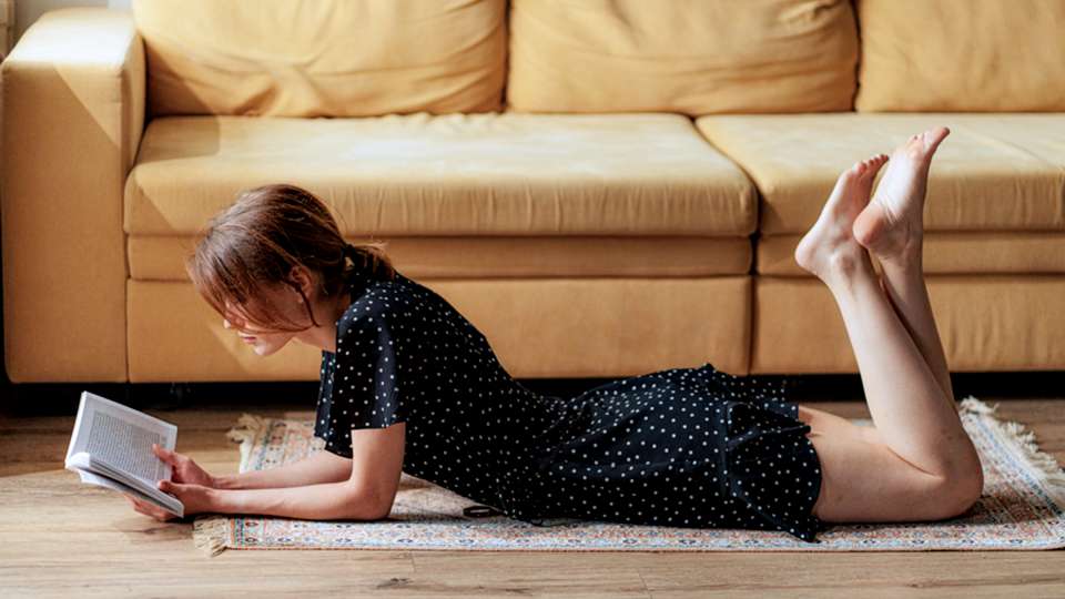 woman reading a book on the floor