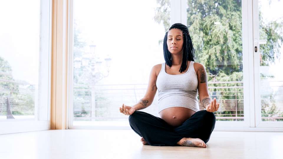 Pregnant woman meditates