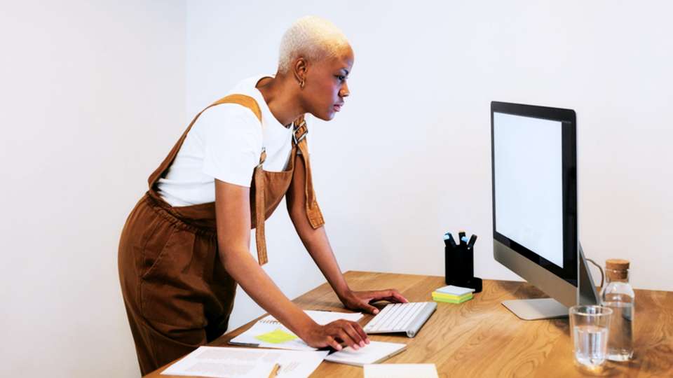 Woman Standing at Computer