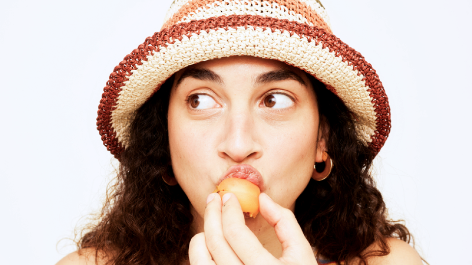 a woman eating fruit