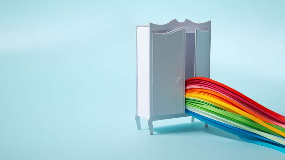 Conceptual art of a rainbow coming out of a closet.