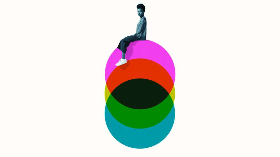 A woman sitting on an illustration of multicolored circles
