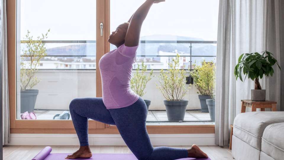 A woman does yoga in her home
