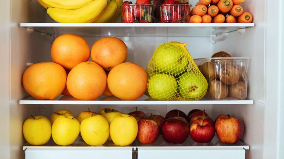 A refrigerator stocked with fruit.