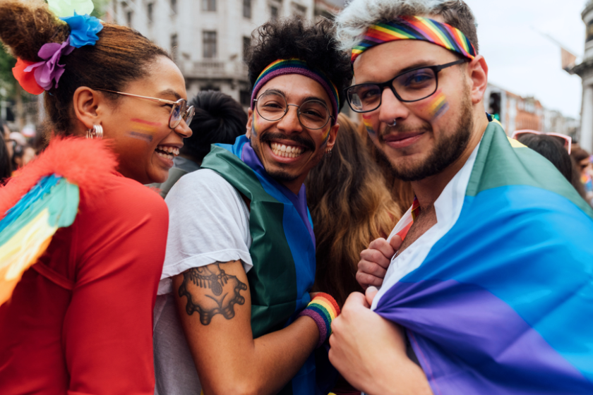A photo of three people at a Pride parade