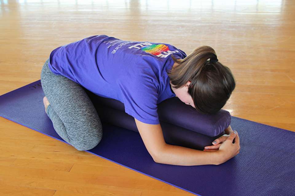 woman doing the yoga pose called child's pose