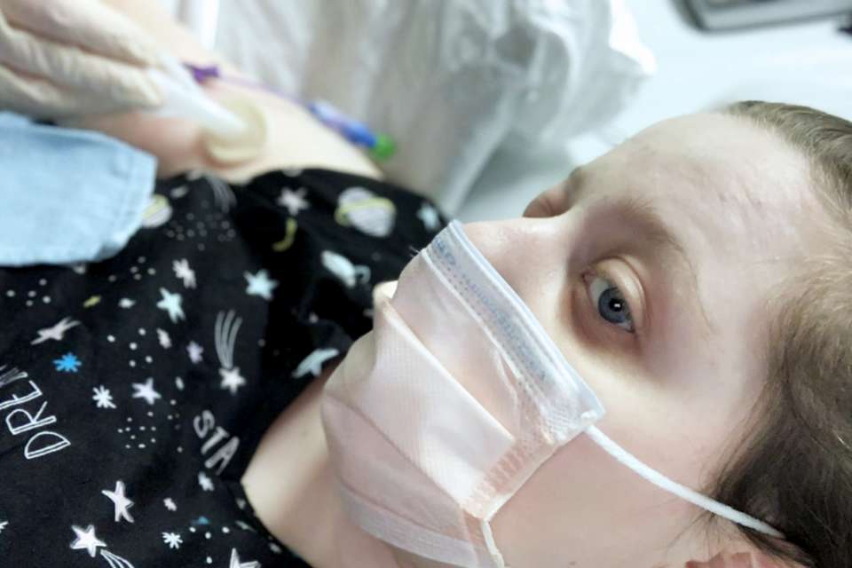 Woman wearing hospital mask.