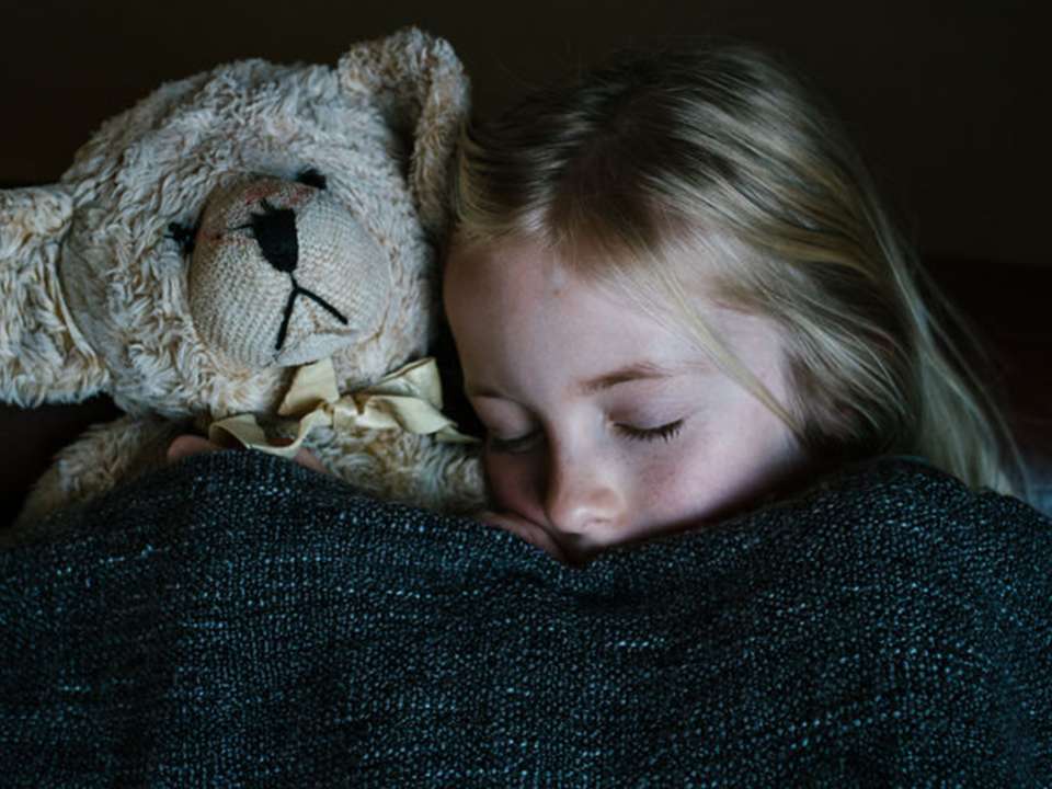 Sleeping girl with teddy bear