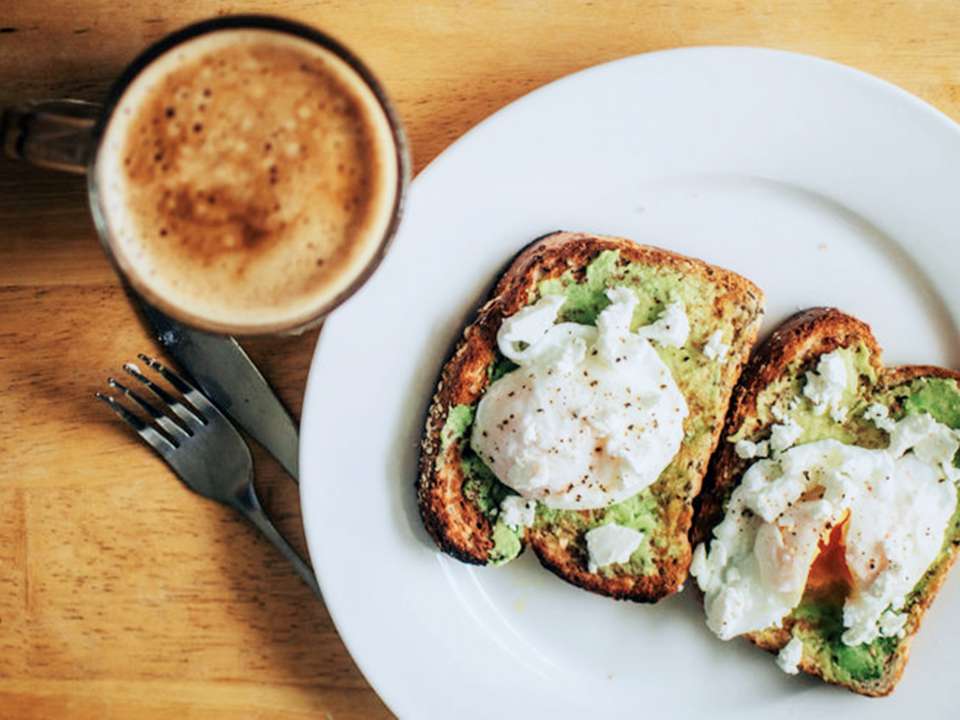 Avocado toast with eggs and a cup of coffee