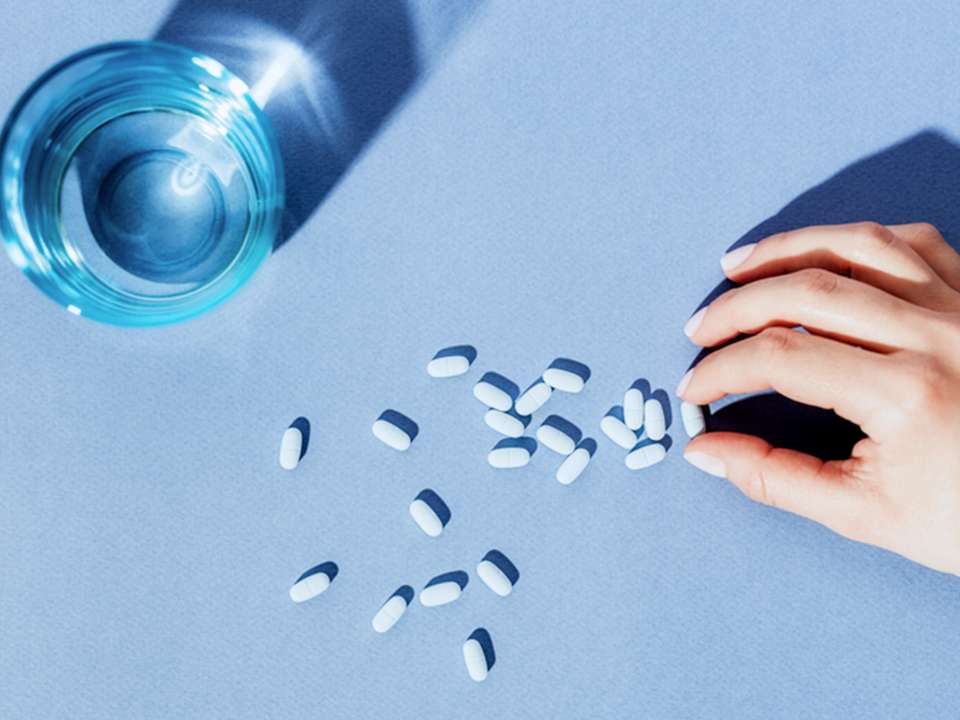 Blue pills on blue background