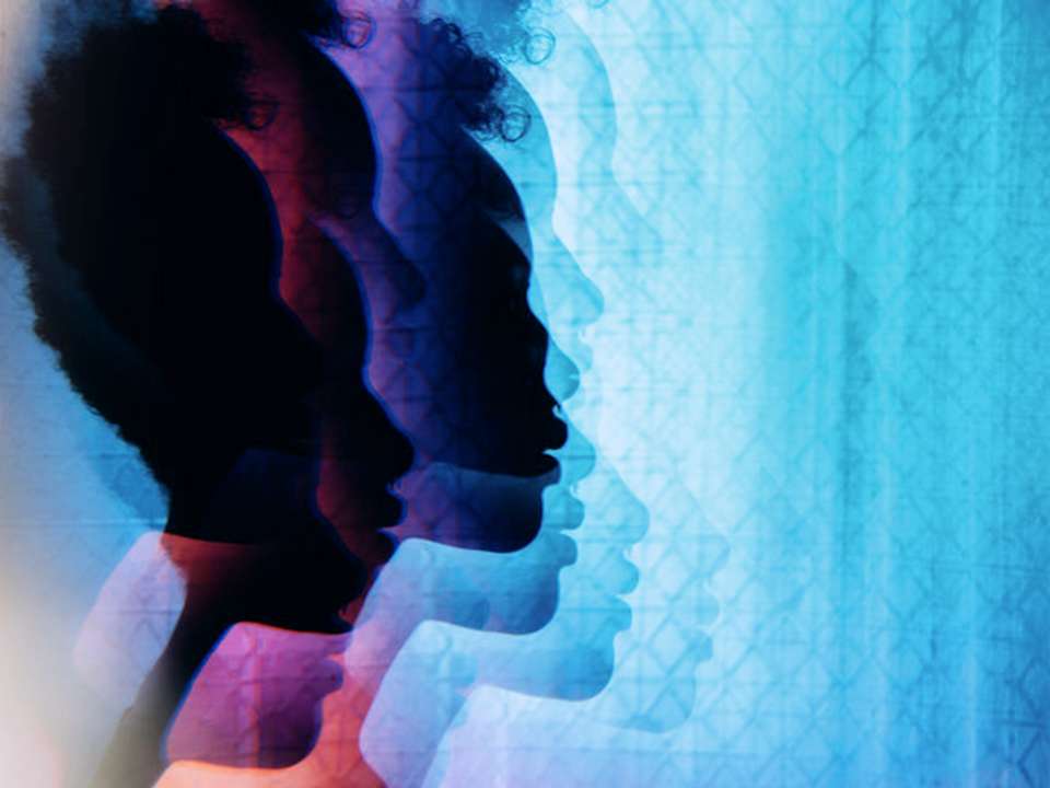 A prismatic image of the silhouette of a woman's head.