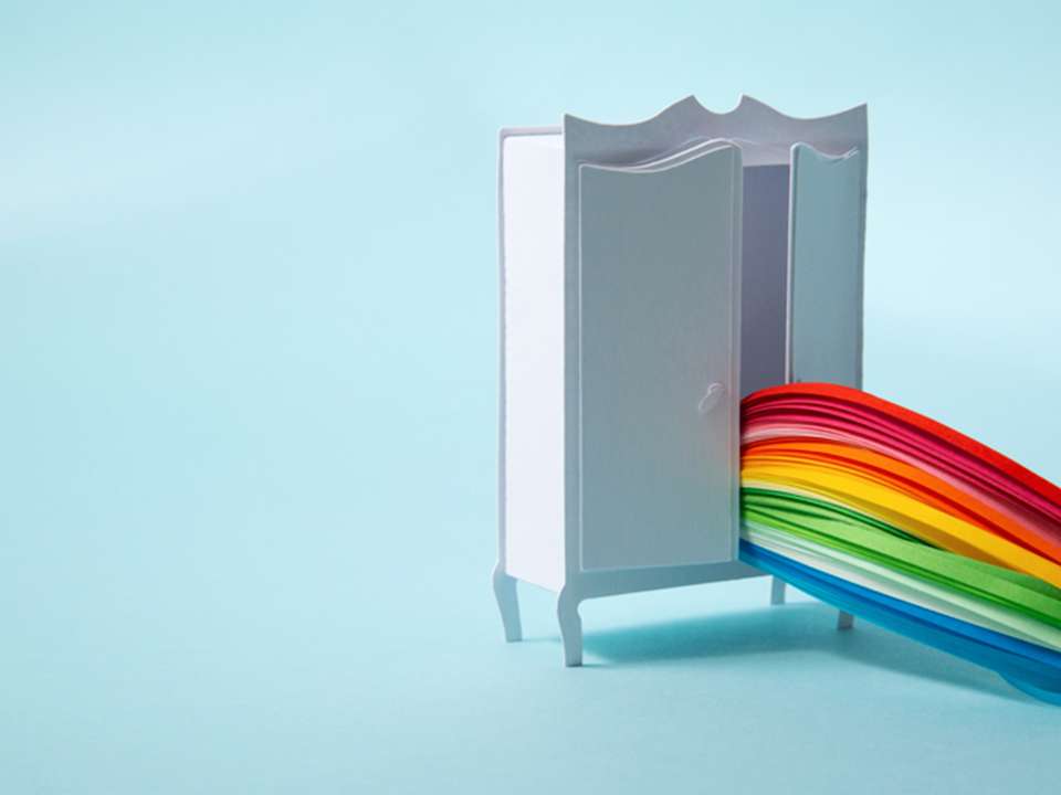 Conceptual art of a rainbow coming out of a closet.