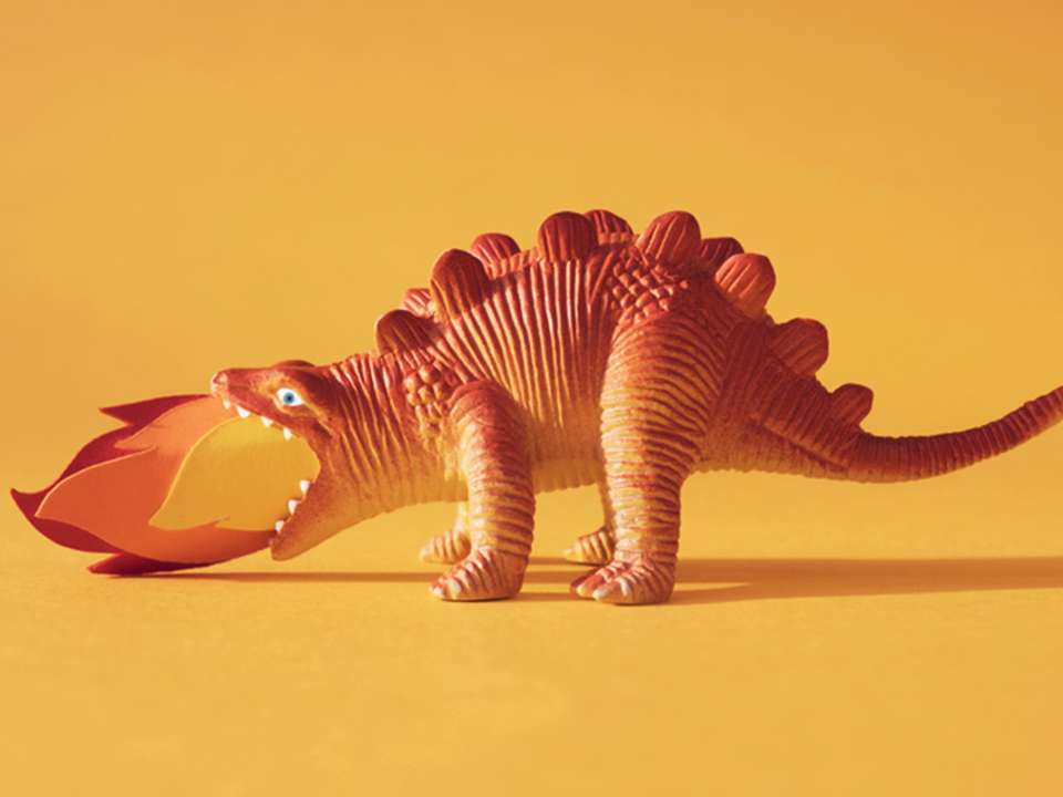 A toy dinosaur breathes fire.