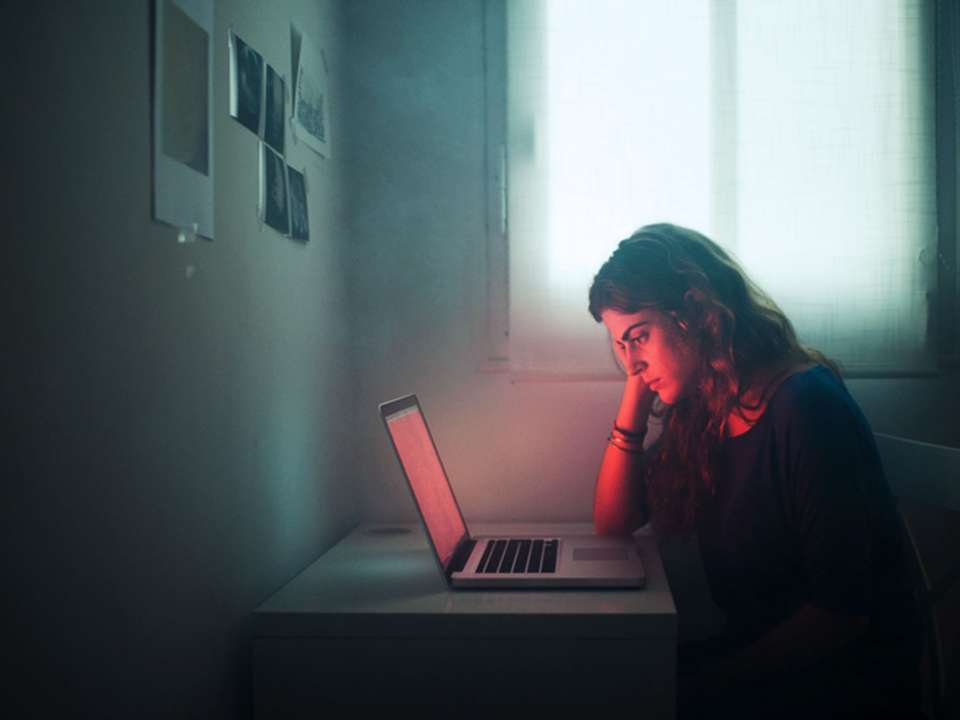 worried woman looking at her computer screen