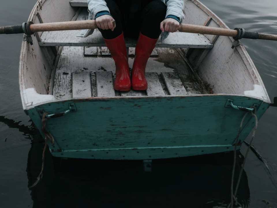 A photo of a person rowing a boat on a body of water