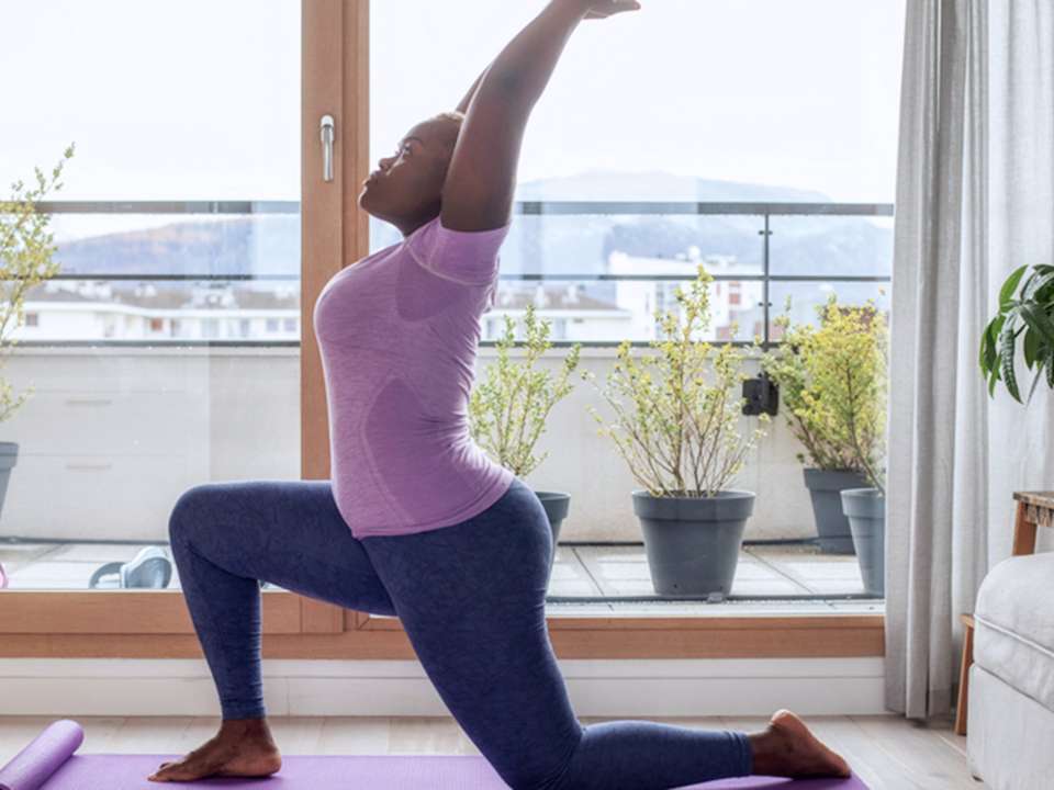 A woman does yoga in her home