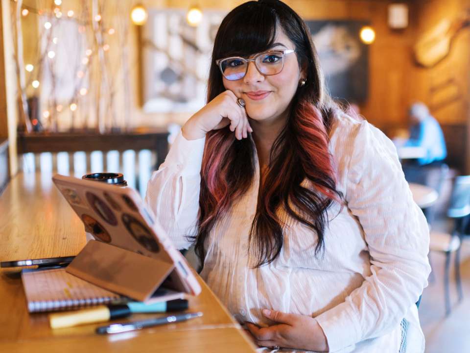 pregnant woman on computer in shop