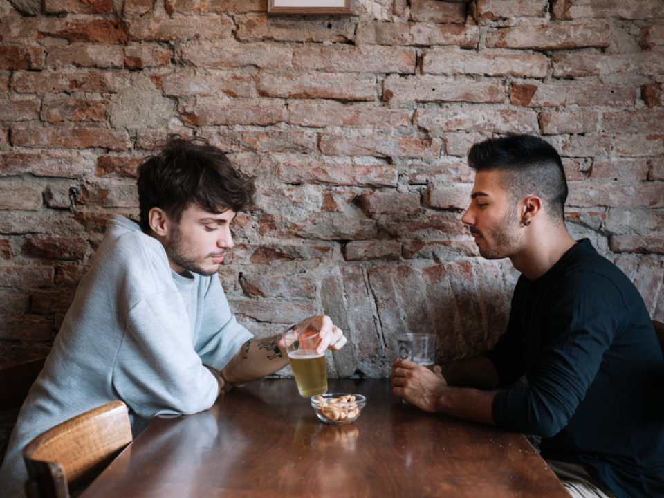 A photo of two men sitting at a table in a restaurant