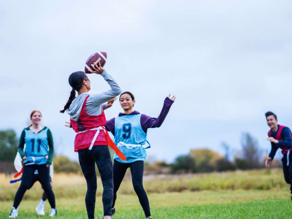 Women playing flag football on a field