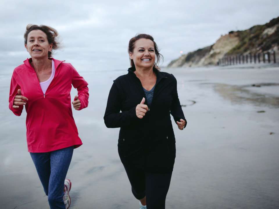 Two women jogging on the beach
